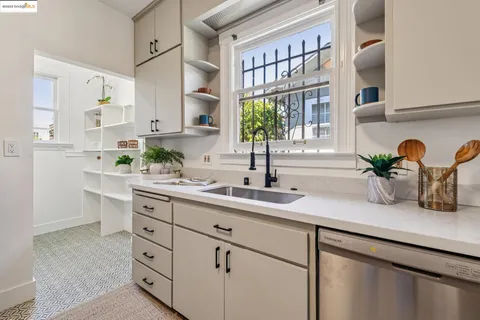 a kitchen with cabinets and window