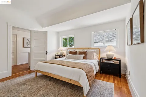 a spacious bedroom with a bed and a potted plant