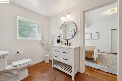 a bedroom with a bed table and a window