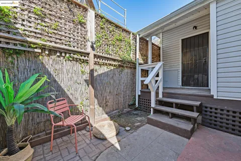 a view of a patio with table and chairs and potted plants