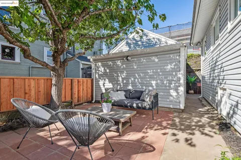 a backyard of a house with table and chairs