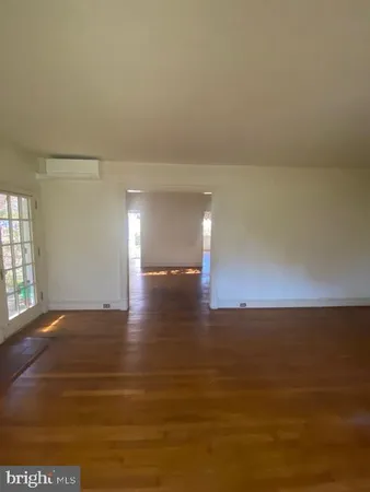 a view of a room with an empty space and a window