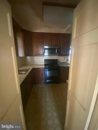 a kitchen with stainless steel appliances a refrigerator and a sink