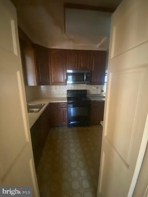7710 Chatham Road Chevy Chase, MD 20815 - Photo 15 of 40 a kitchen with stainless steel appliances a refrigerator and a sink