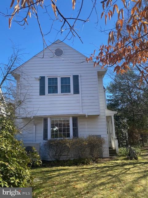 7710 Chatham Road Chevy Chase, MD 20815 - Photo 6 of 40 a front view of a house with a yard