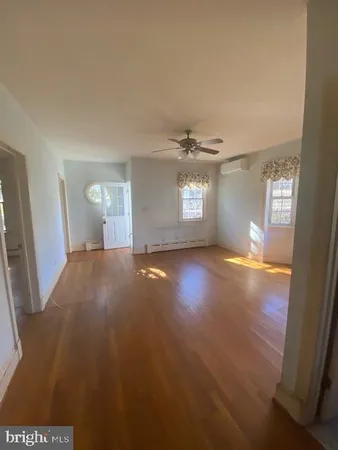 a view of empty room with window and fireplace
