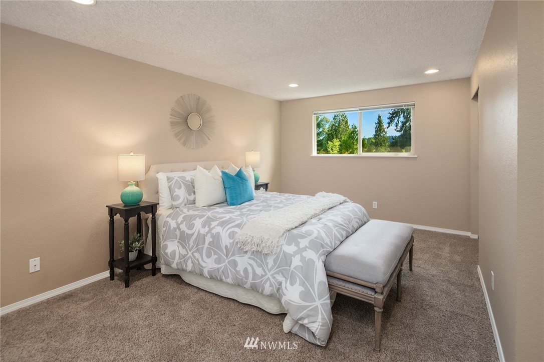 1131 202nd Street Southeast Bothell, WA 98012 - Photo 14 of 24 a bedroom with a bed and a lamp on table
