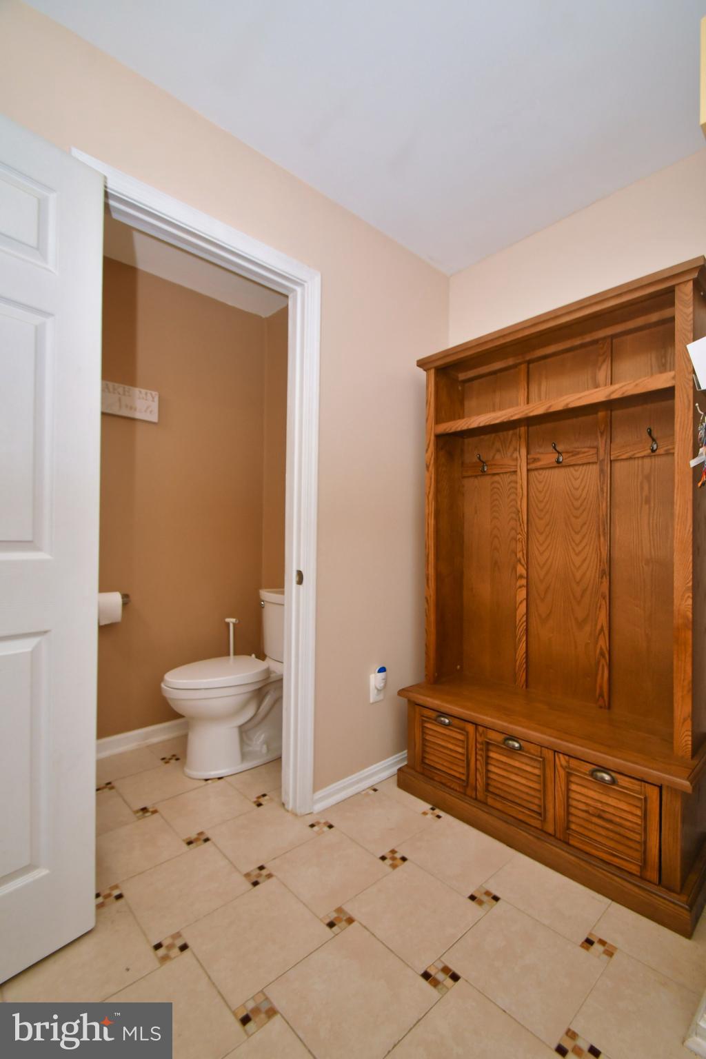 Main Floor 1/2 Bath off Foyer- Comes w/ Wall tree!