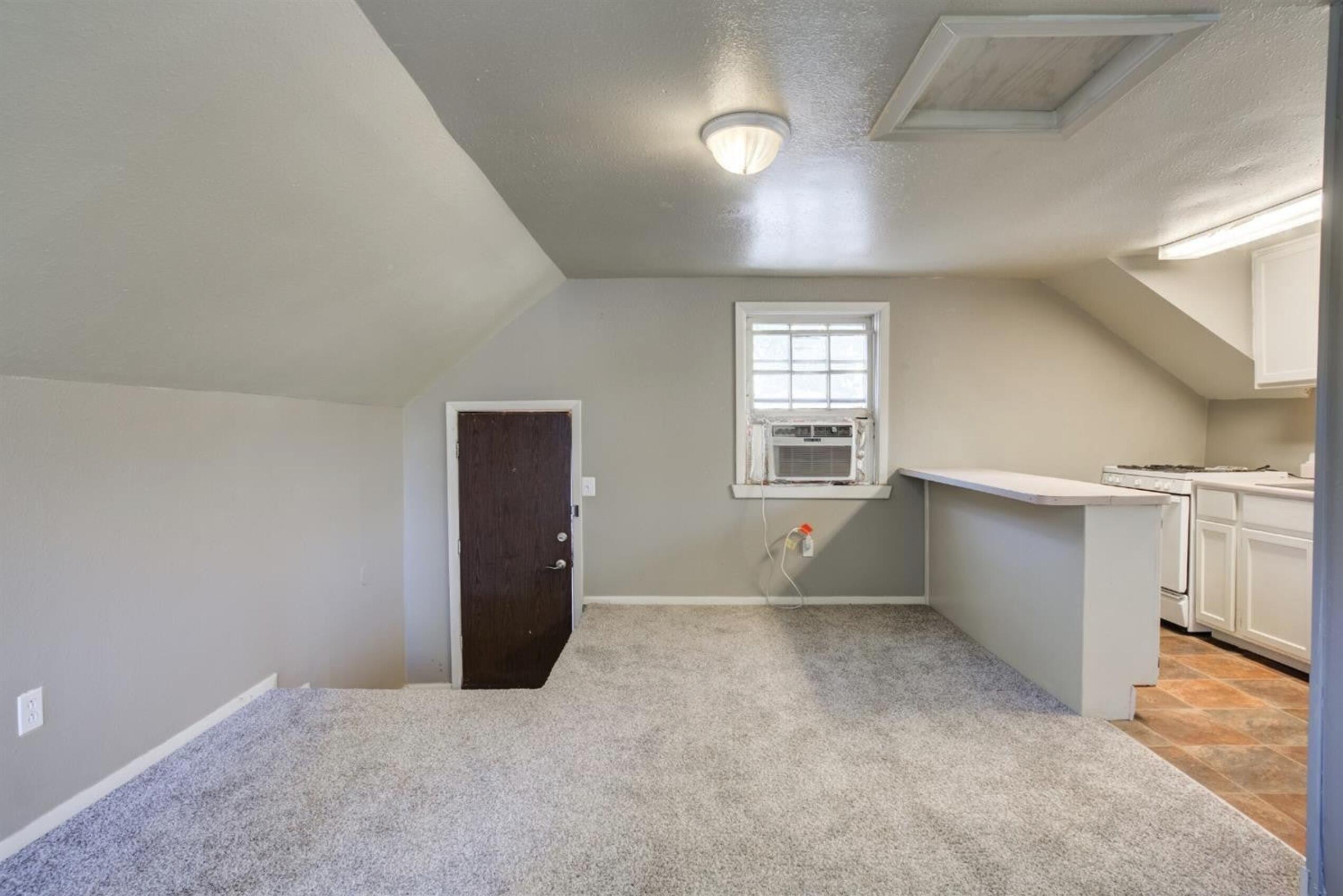 2702 20th Street Lubbock, TX 79410 - Photo 32 of 34 an empty room with windows and pillars in it