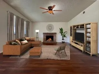 a living room with furniture a fireplace and a flat screen tv