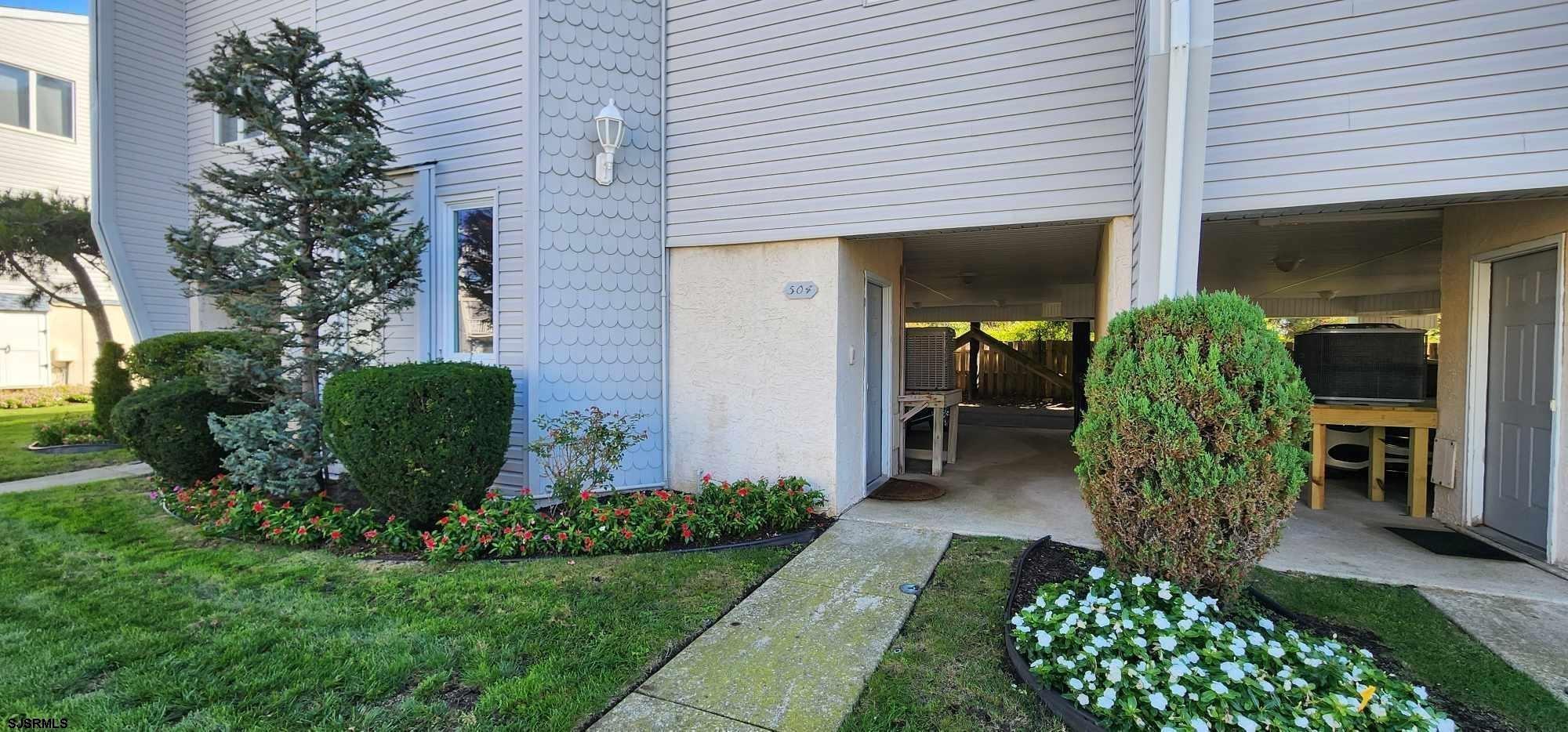 504 East Brigantine Avenue, Unit 504 Brigantine, NJ 08203 - Photo 11 of 43 a front view of a house with garden