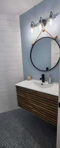 a bathroom with a toilet and a mirror
