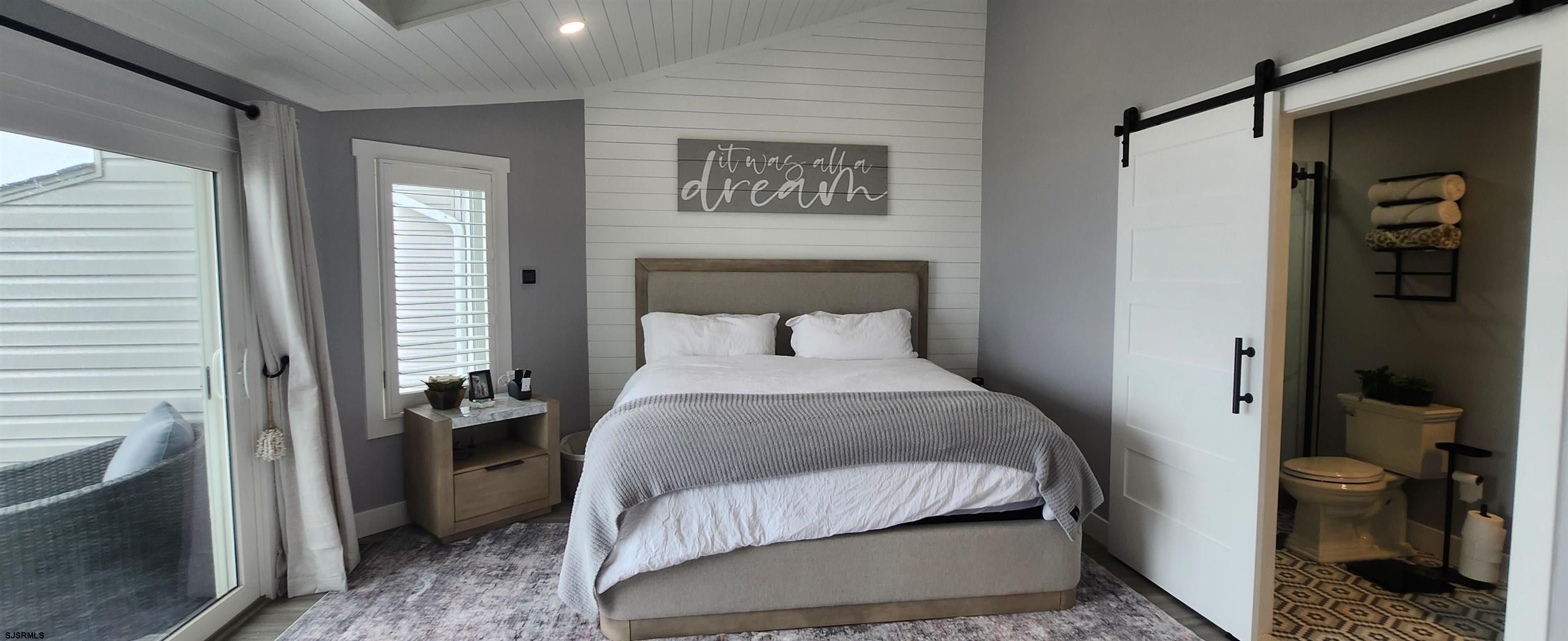 504 East Brigantine Avenue, Unit 504 Brigantine, NJ 08203 - Photo 27 of 43 a bedroom with a bed and a view of bathroom