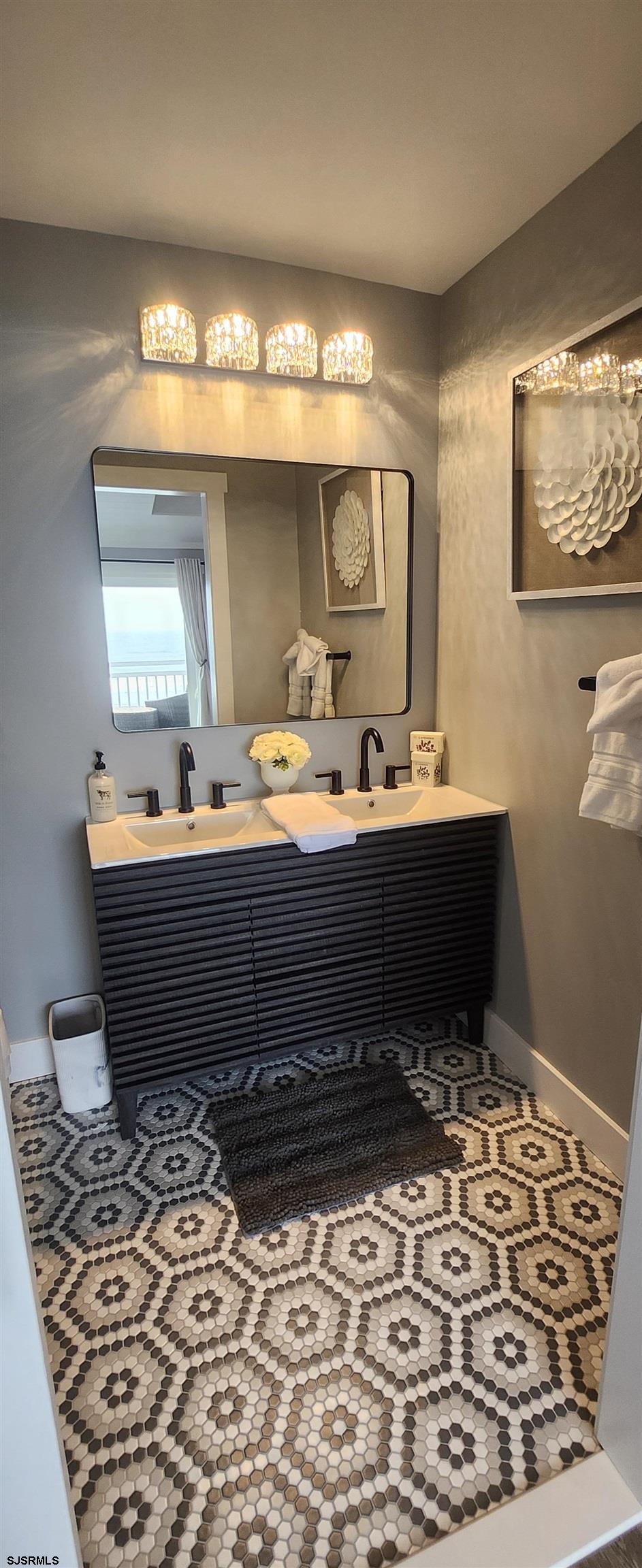 504 East Brigantine Avenue, Unit 504 Brigantine, NJ 08203 - Photo 32 of 43 a room with a mirror and a sink