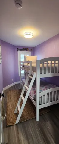 a bedroom with a bed and a mirror