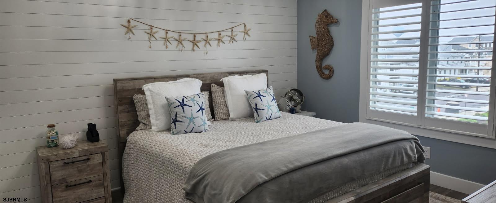 504 East Brigantine Avenue, Unit 504 Brigantine, NJ 08203 - Photo 37 of 43 a bedroom with a bed and a mirror