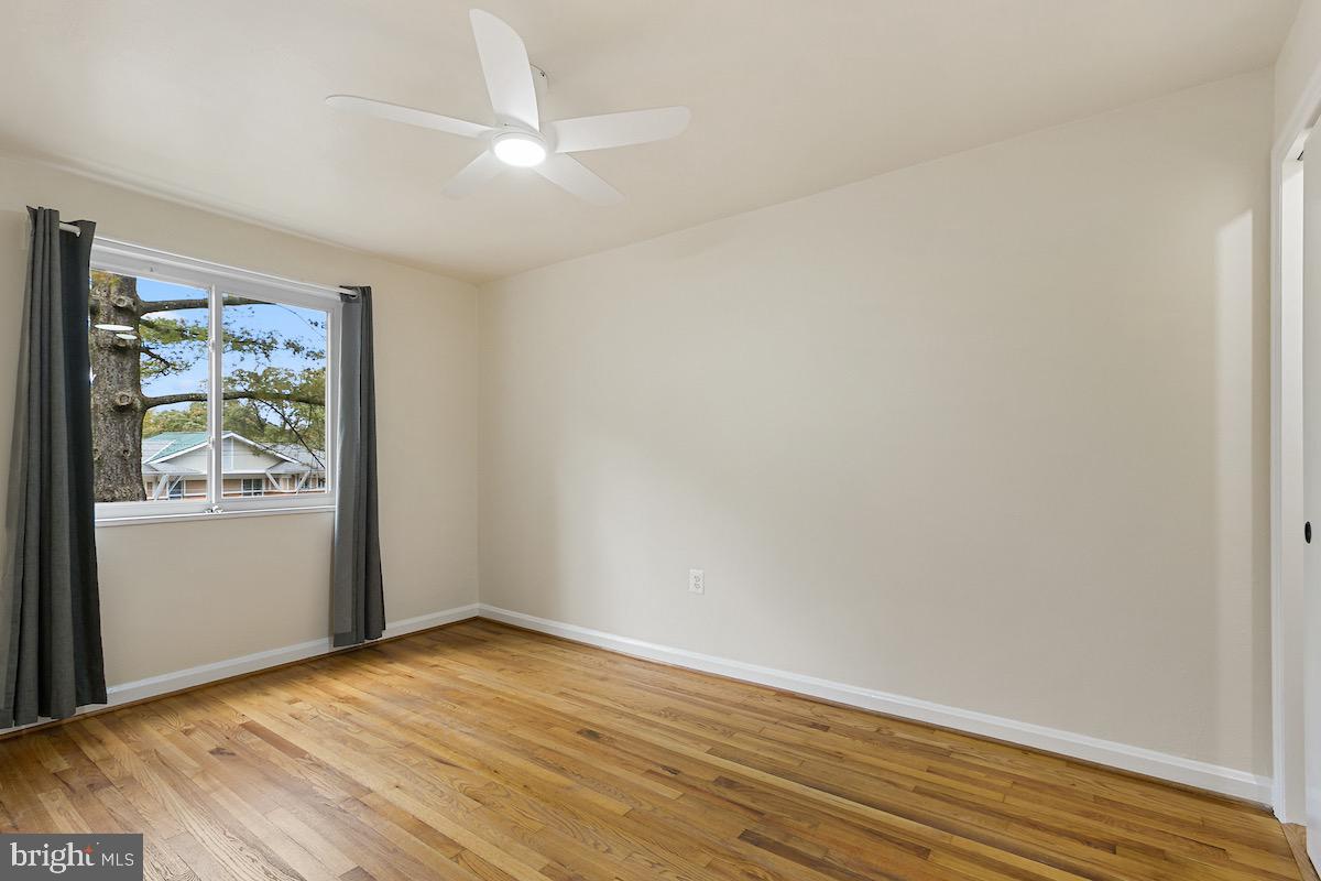9003 Manchester Road, Unit 9003 Silver Spring, MD 20901 - Photo 20 of 53 an empty room with wooden floor and window