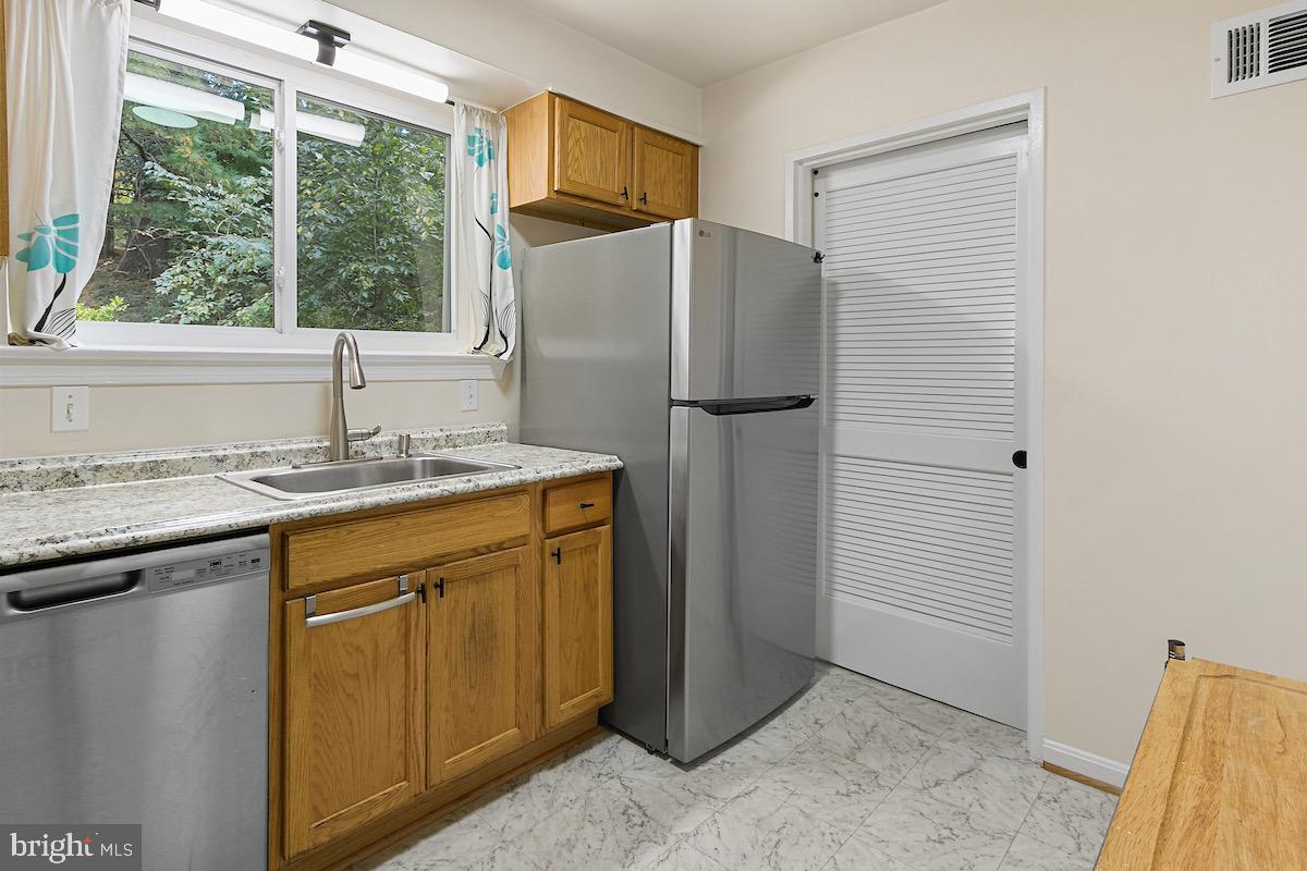 9003 Manchester Road, Unit 9003 Silver Spring, MD 20901 - Photo 2 of 53 a kitchen with a refrigerator and a sink