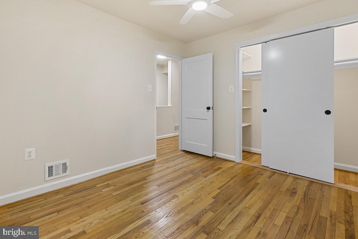 9003 Manchester Road, Unit 9003 Silver Spring, MD 20901 - Photo 23 of 53 a view of an empty room with wooden floor