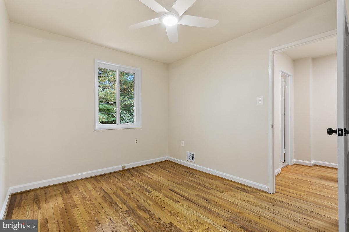 9003 Manchester Road, Unit 9003 Silver Spring, MD 20901 - Photo 24 of 53 an empty room with wooden floor and windows