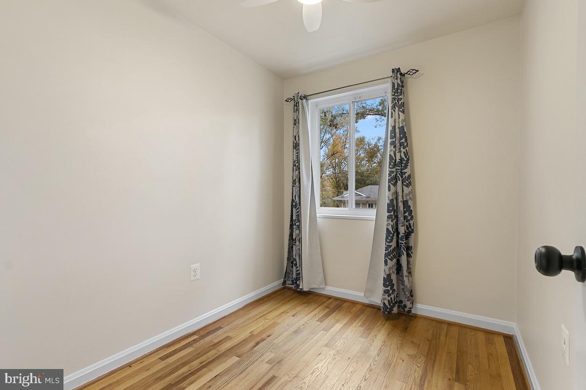 9003 Manchester Road, Unit 9003 Silver Spring, MD 20901 - Photo 25 of 53 an empty room with wooden floor and windows