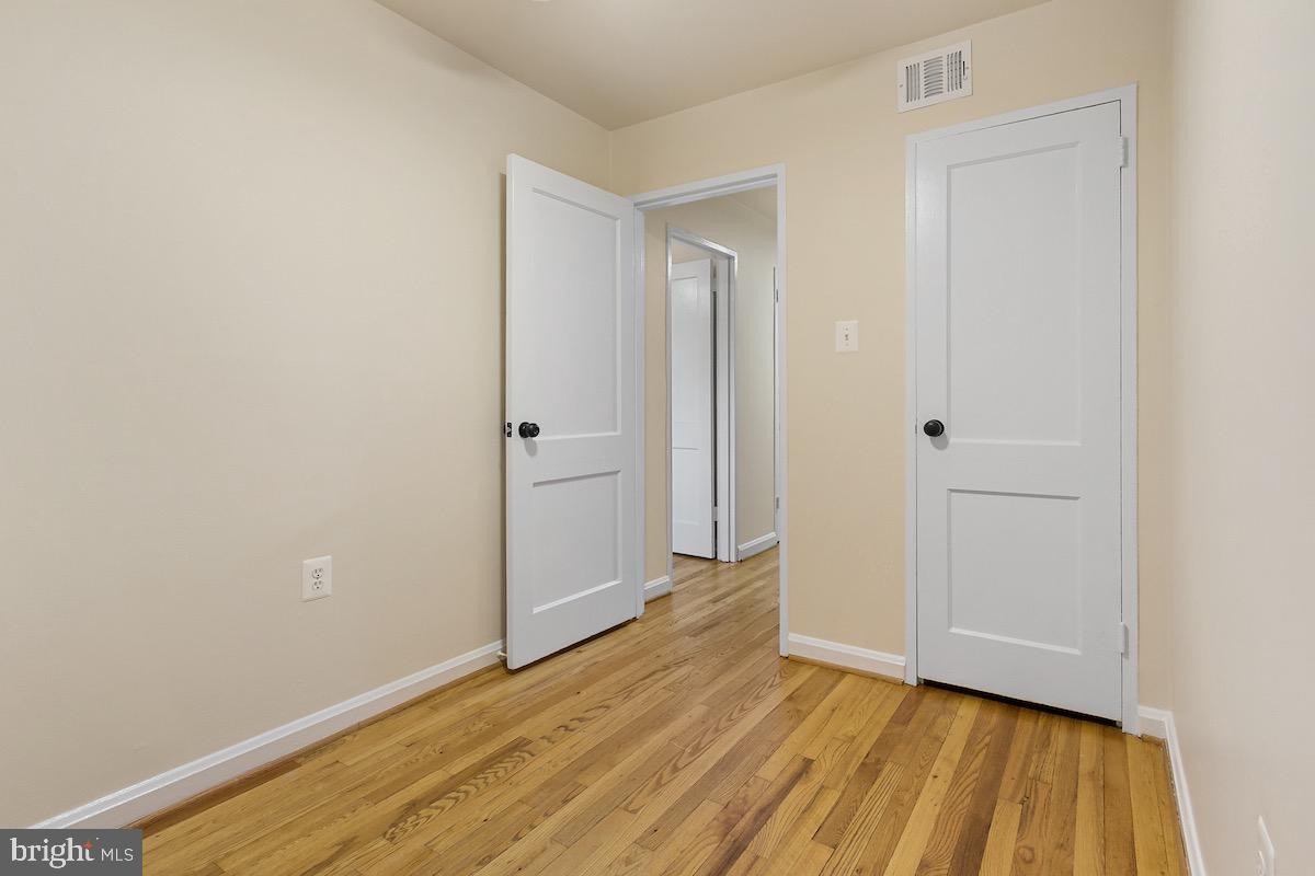 9003 Manchester Road, Unit 9003 Silver Spring, MD 20901 - Photo 26 of 53 a view of an empty room with wooden floor