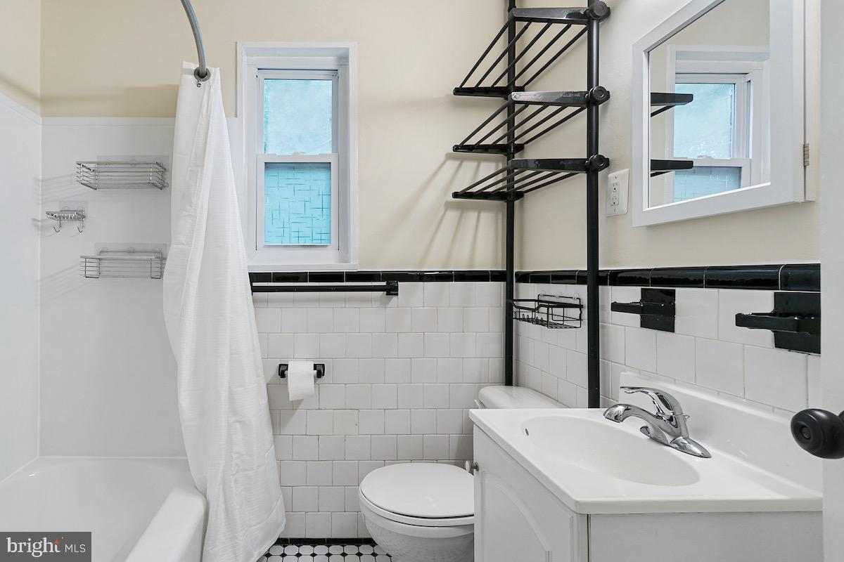9003 Manchester Road, Unit 9003 Silver Spring, MD 20901 - Photo 29 of 53 a bathroom with a sink a toilet and shower