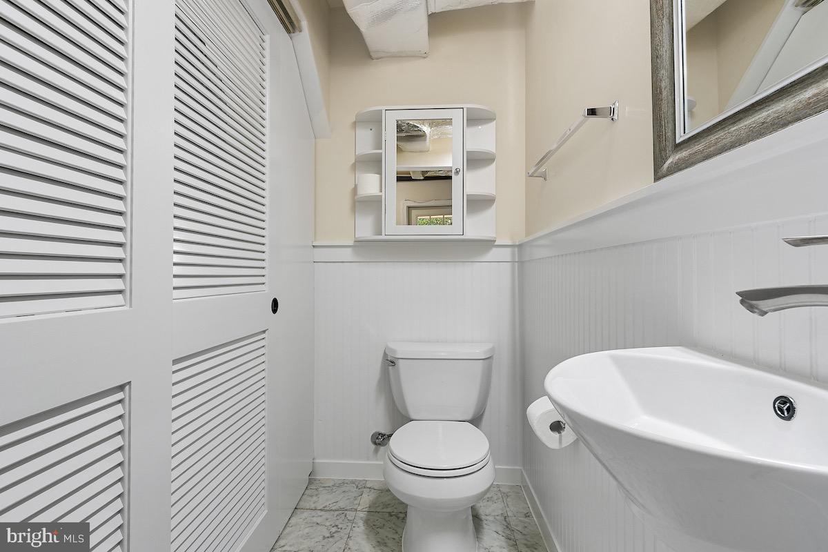 9003 Manchester Road, Unit 9003 Silver Spring, MD 20901 - Photo 32 of 53 a white toilet sitting next to a bathroom sink