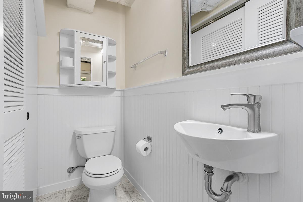 9003 Manchester Road, Unit 9003 Silver Spring, MD 20901 - Photo 33 of 53 a bathroom with a sink toilet and mirror