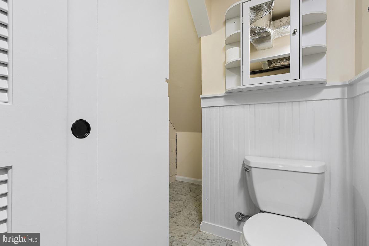 9003 Manchester Road, Unit 9003 Silver Spring, MD 20901 - Photo 34 of 53 a white toilet sitting next to a bathroom sink and a mirror