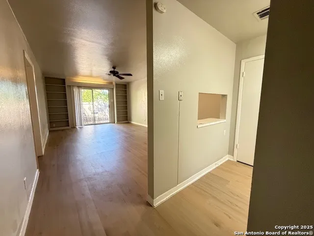 a view of a hallway view with wooden floor and staircase