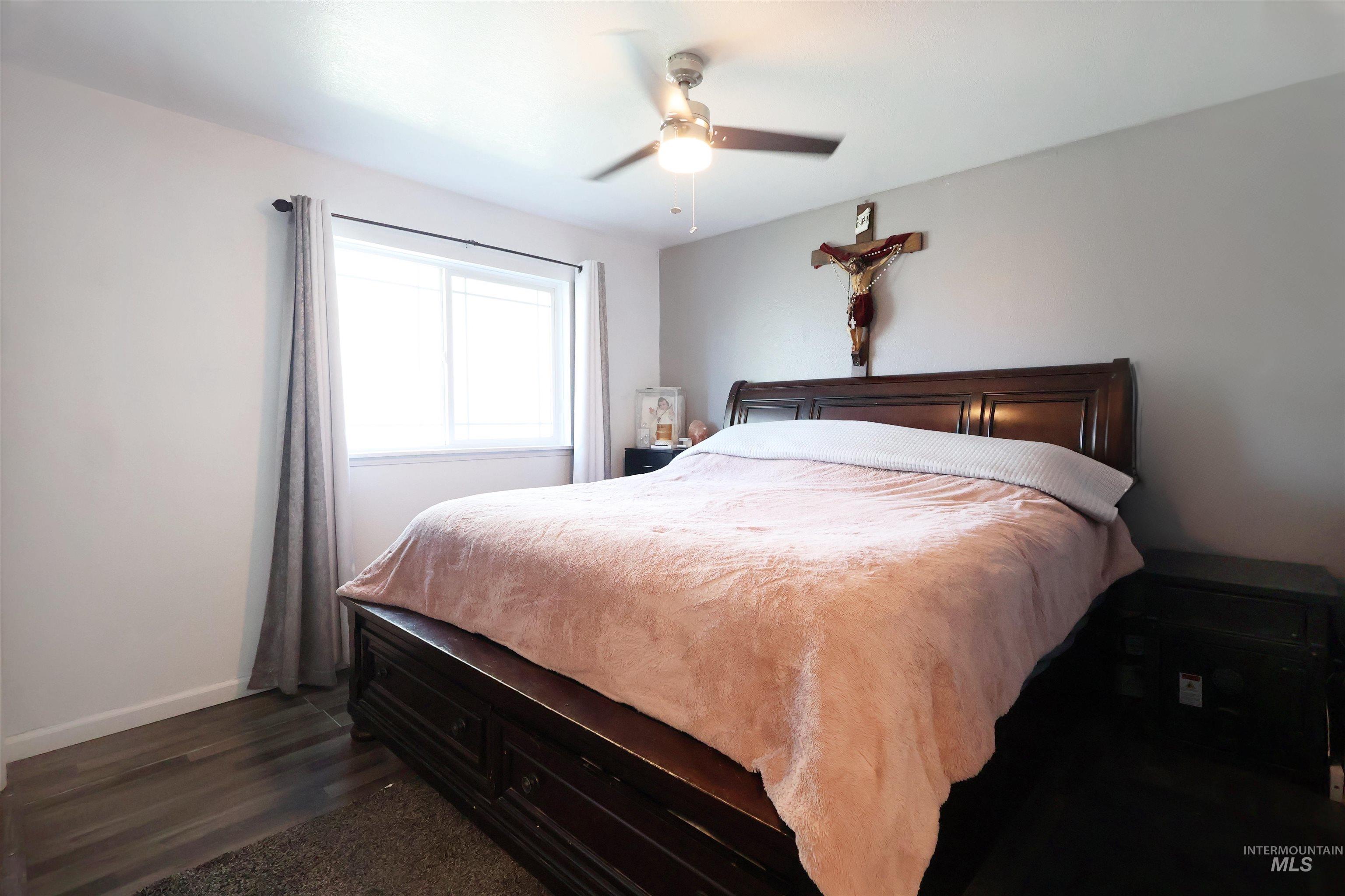 412 Linden Street Rupert, ID 83350 - Photo 13 of 17 Bedroom with ceiling fan and dark wood-style flooring