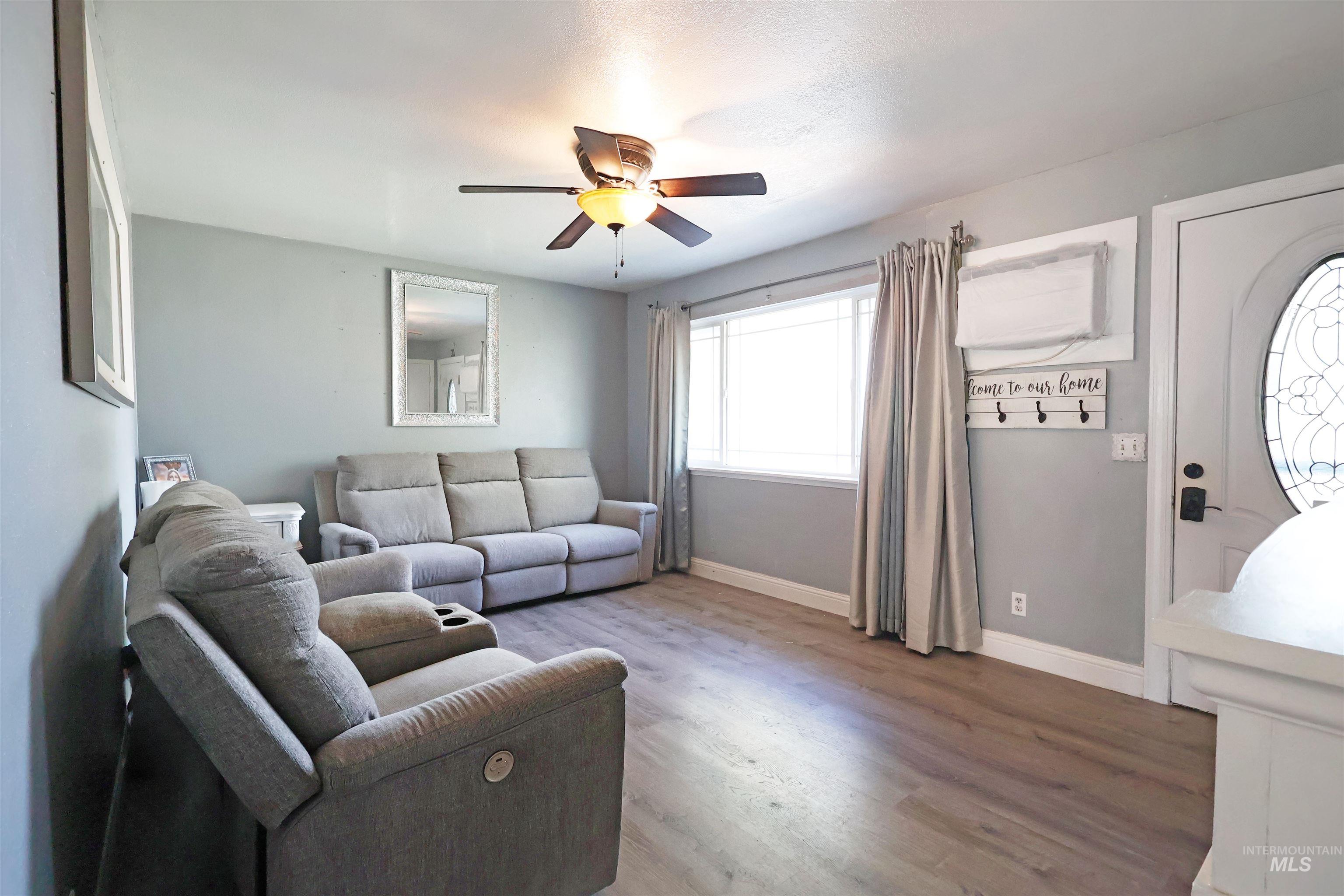 412 Linden Street Rupert, ID 83350 - Photo 3 of 17 Living area featuring wood finished floors and ceiling fan