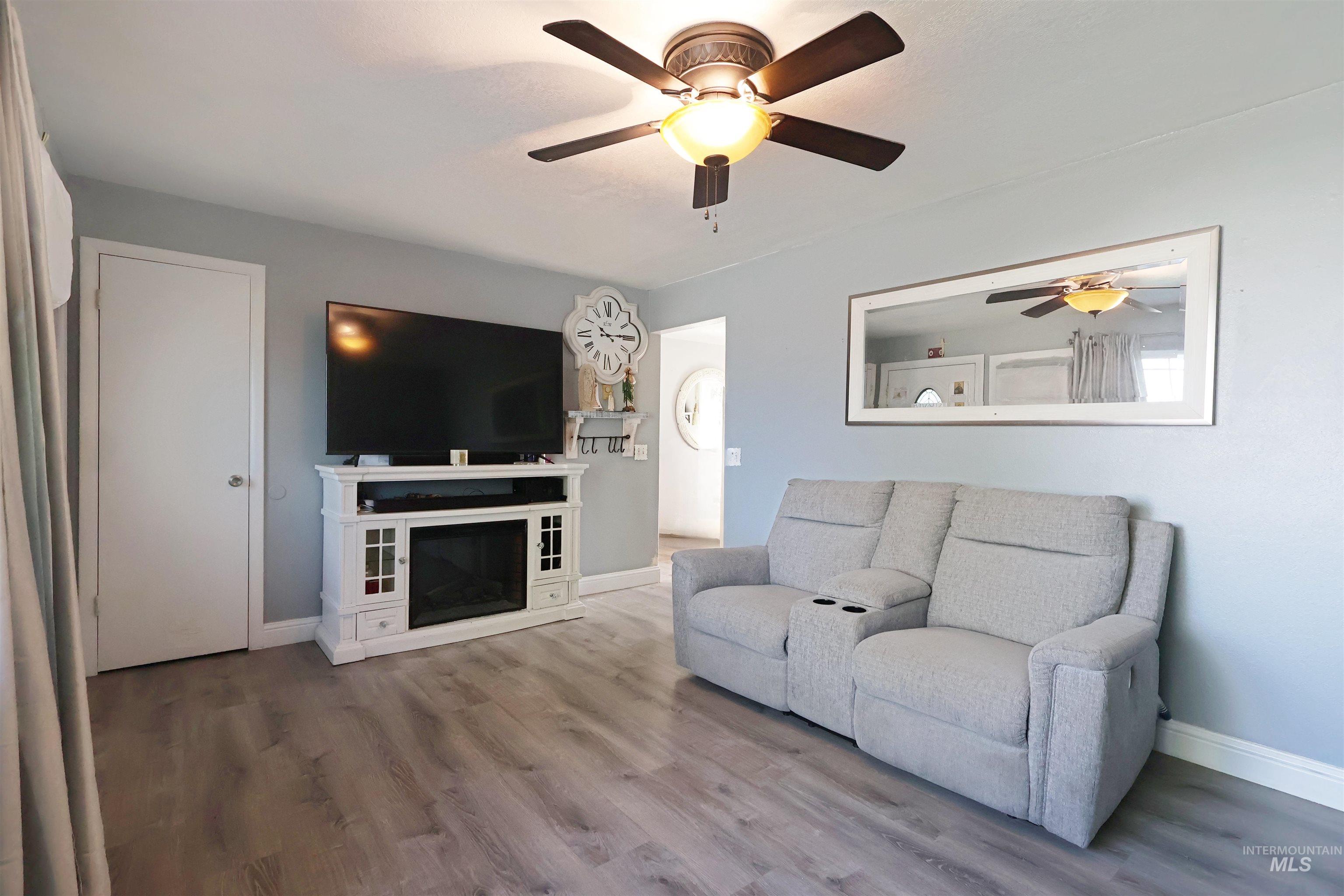 412 Linden Street Rupert, ID 83350 - Photo 4 of 17 Living room with a ceiling fan and light wood-style floors