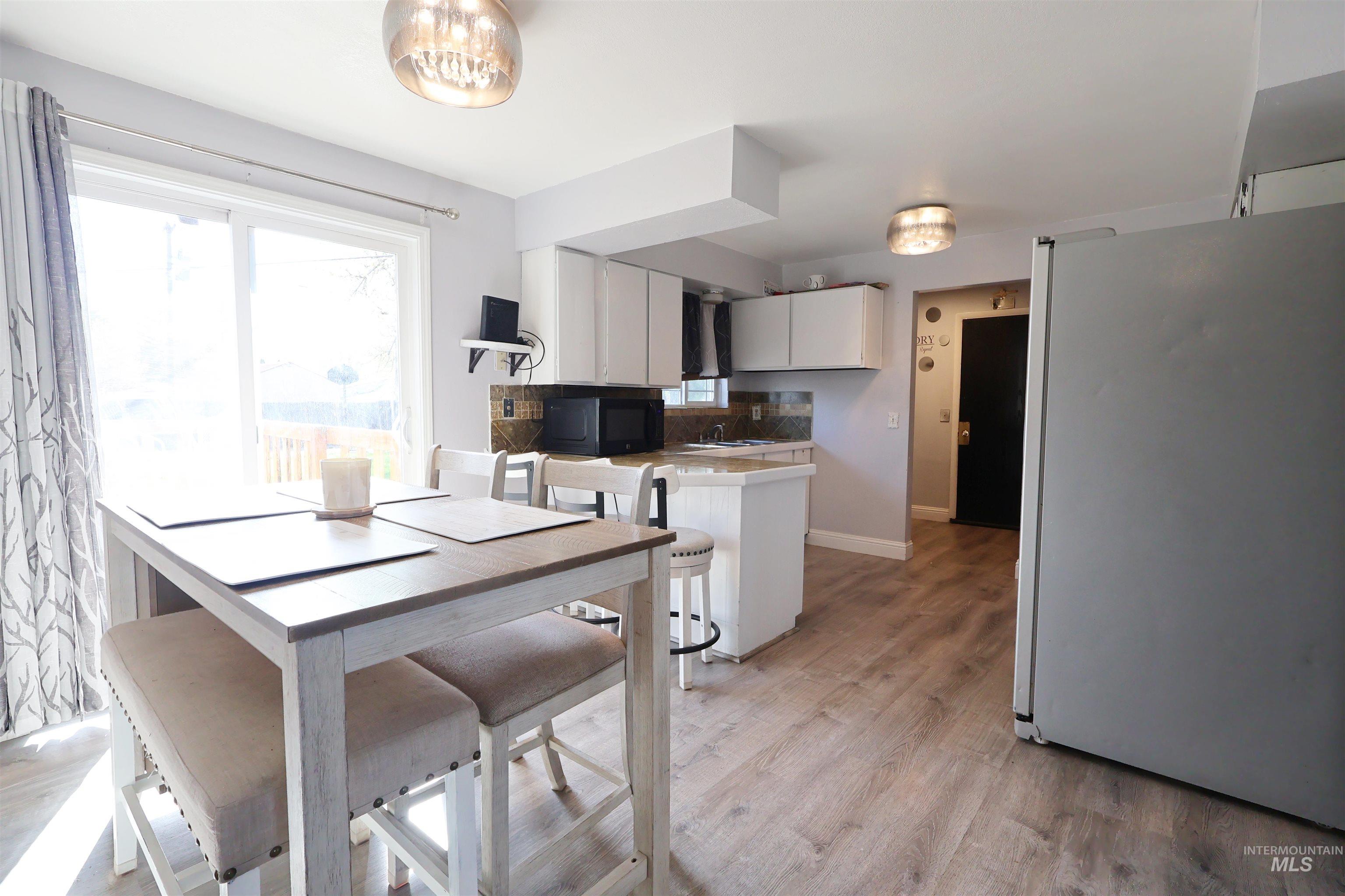 412 Linden Street Rupert, ID 83350 - Photo 5 of 17 Dining space with light wood-type flooring and baseboards