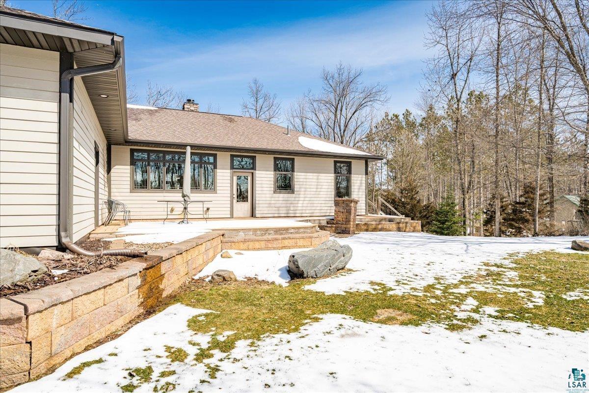 92598 Spells Road Sturgeon Lake, MN 55783 - Photo 52 of 60 Snow covered house with a chimney and a patio area