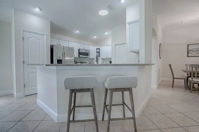 a kitchen with cabinets stainless steel appliances and a counter top space