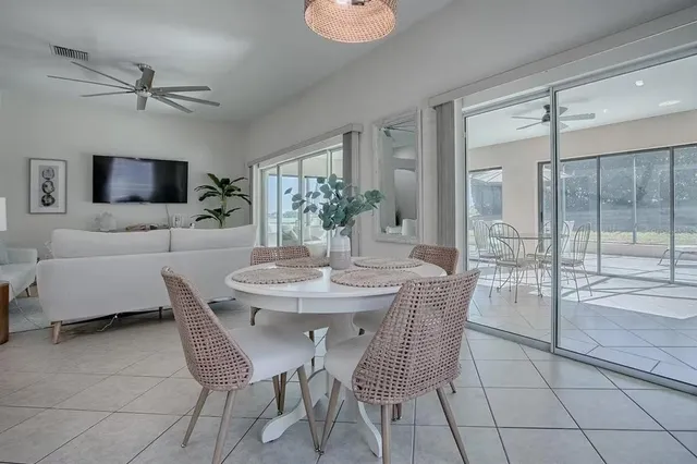 a living room with furniture and a glass door shower