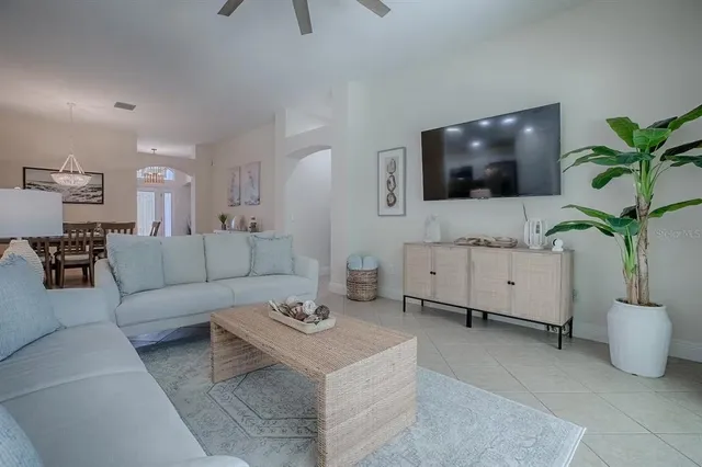 a living room with furniture and a floor to ceiling window