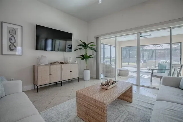 a kitchen with stainless steel appliances granite countertop a stove a sink a microwave a refrigerator and white cabinets with wooden floor