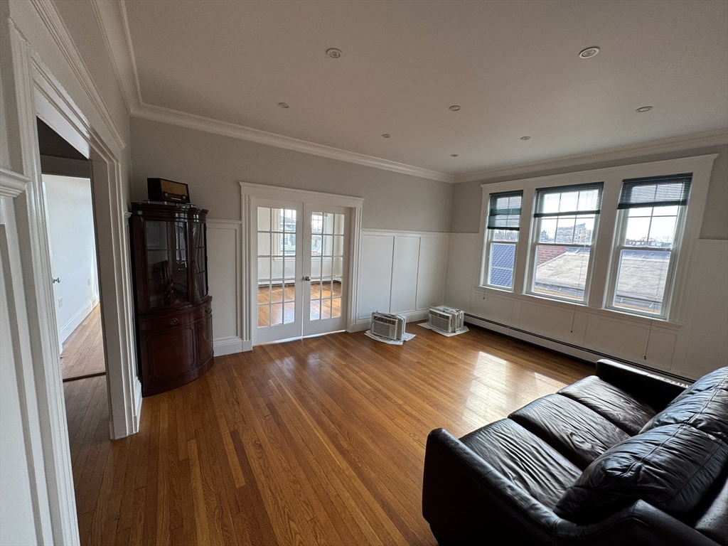 84 Tudor Street, Unit 6 Chelsea, MA 02150 - Photo 3 of 14 a living room with furniture and a window