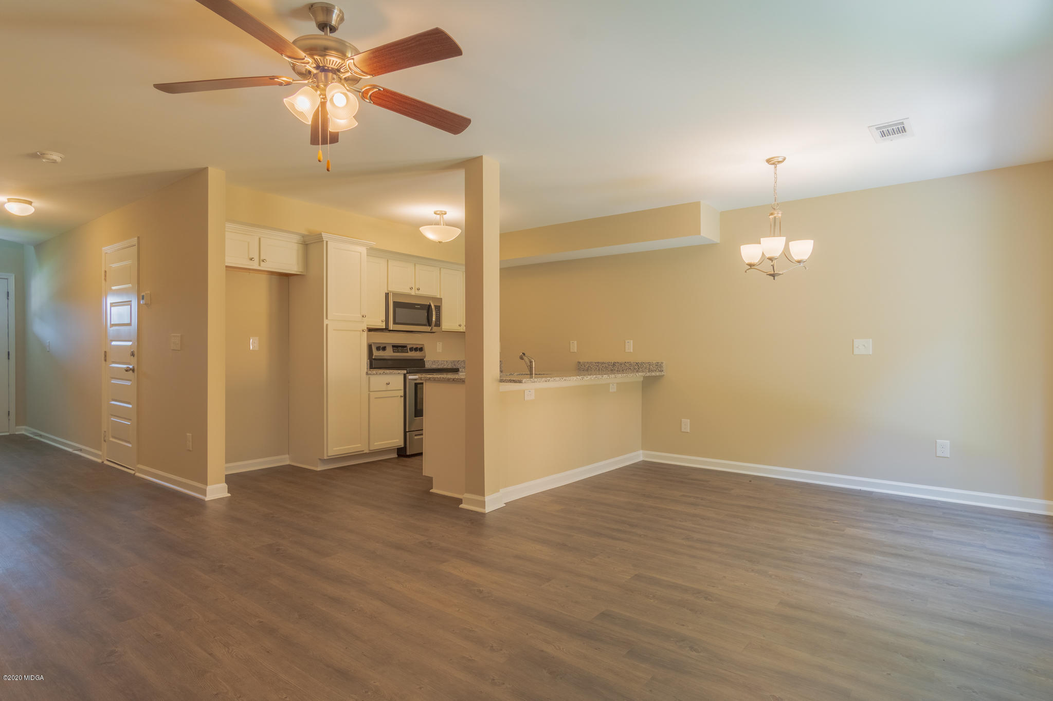 321 Pond View Road Macon, GA 31206 - Photo 3 of 22 a view of a kitchen with wooden floor and a ceiling fan