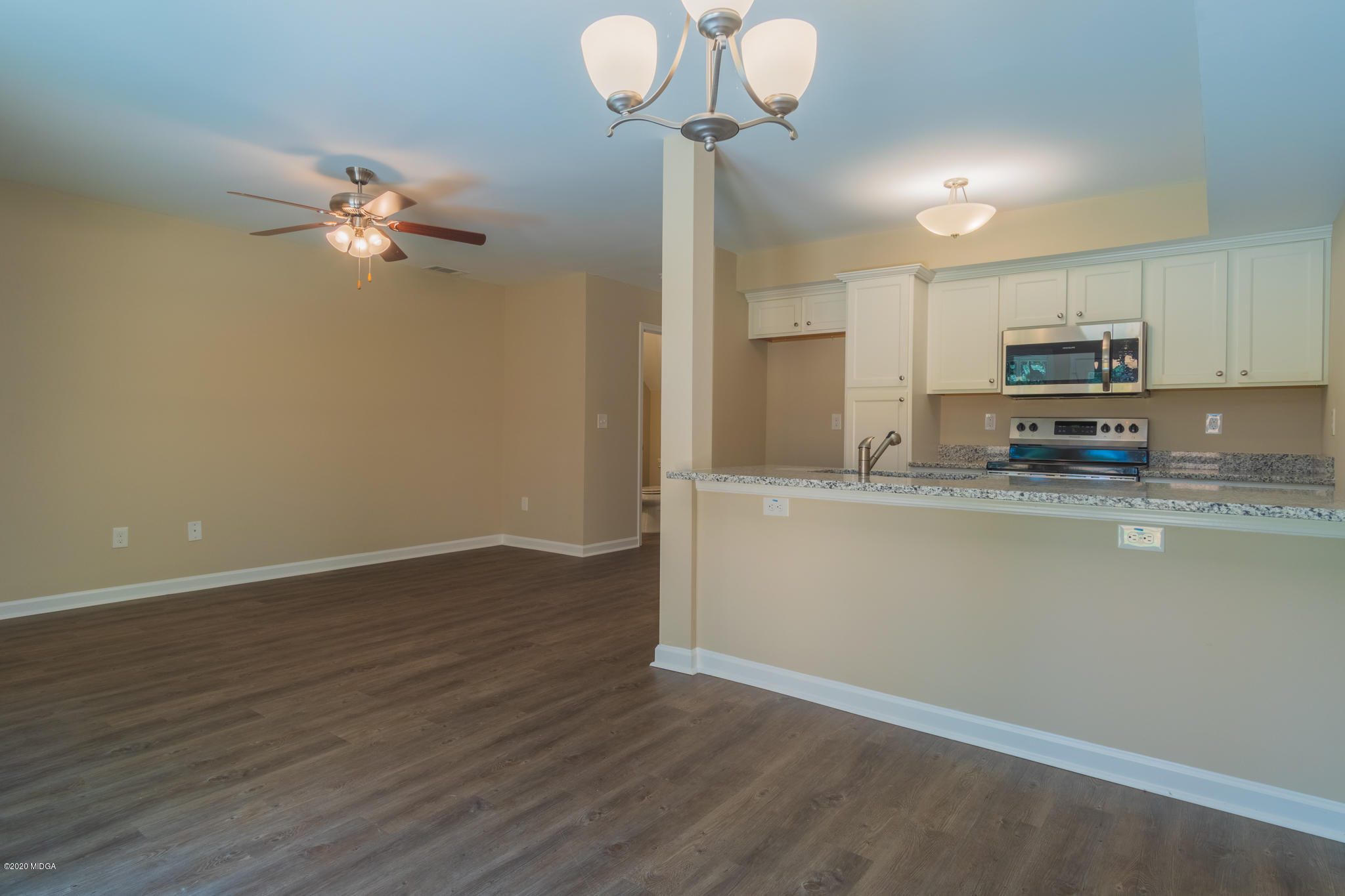 321 Pond View Road Macon, GA 31206 - Photo 4 of 22 a view of a kitchen with wooden floor and a fan