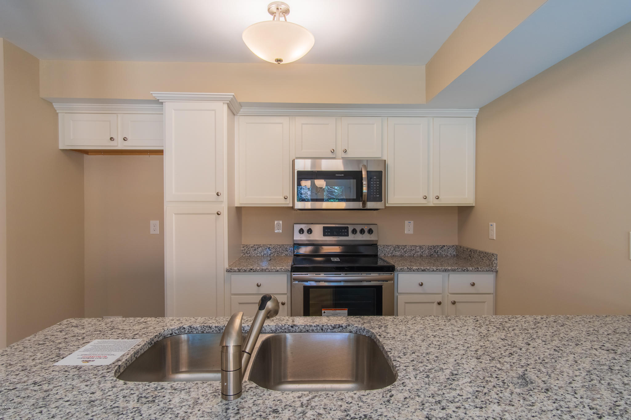 321 Pond View Road Macon, GA 31206 - Photo 5 of 22 a kitchen with stainless steel appliances a sink a stove a microwave a counter top space and cabinets