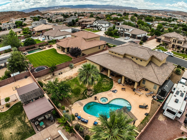 3683 South 2640 West St. George, UT 84790 - Photo 7 of 41 Expansive backyard featuring a large swimming pool with an integrated spa, ample patio space, and mature palm trees