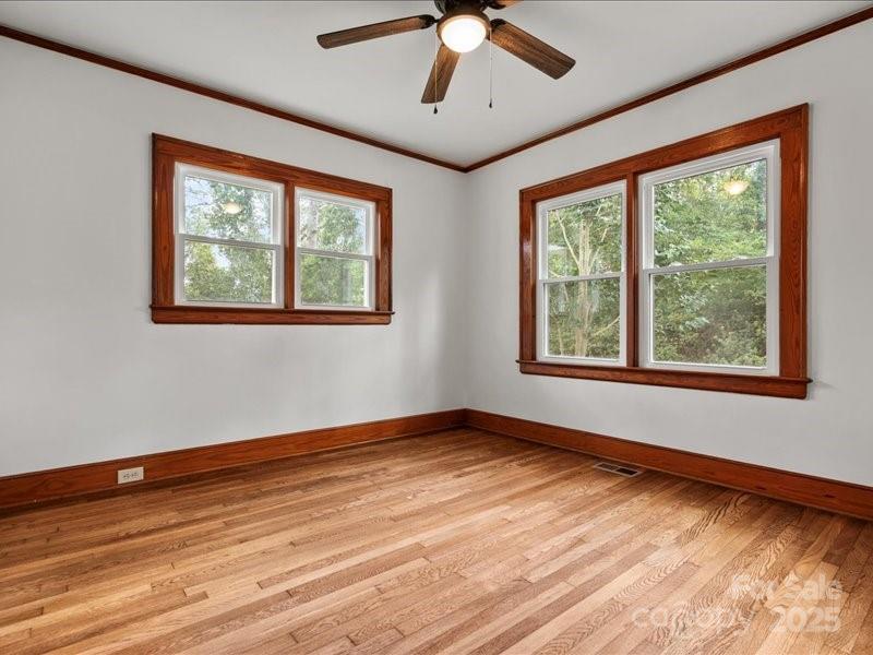 37 Lynn Avenue Cheraw, SC 29520 - Photo 11 of 30 a view of an empty room with wooden floor and a window