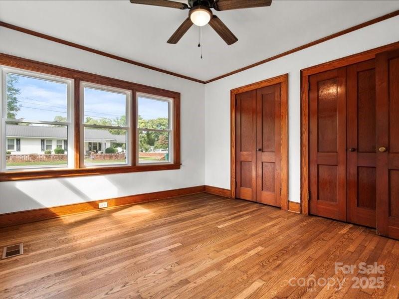 37 Lynn Avenue Cheraw, SC 29520 - Photo 15 of 30 an empty room with wooden floor chandelier and windows
