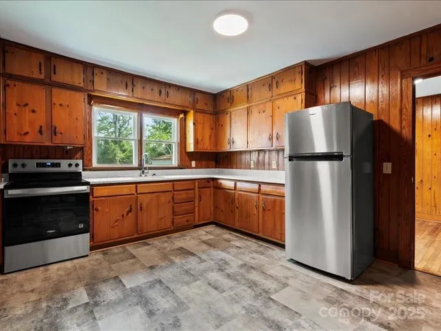 a kitchen with a refrigerator and a stove