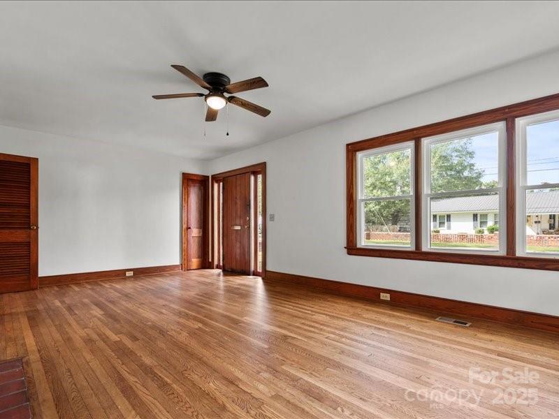 37 Lynn Avenue Cheraw, SC 29520 - Photo 6 of 30 a view of an empty room with a window and wooden floor