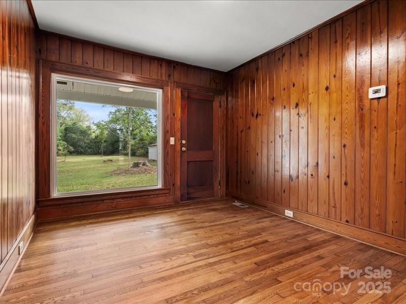 37 Lynn Avenue Cheraw, SC 29520 - Photo 8 of 30 a view of an empty room with wooden floor and a window